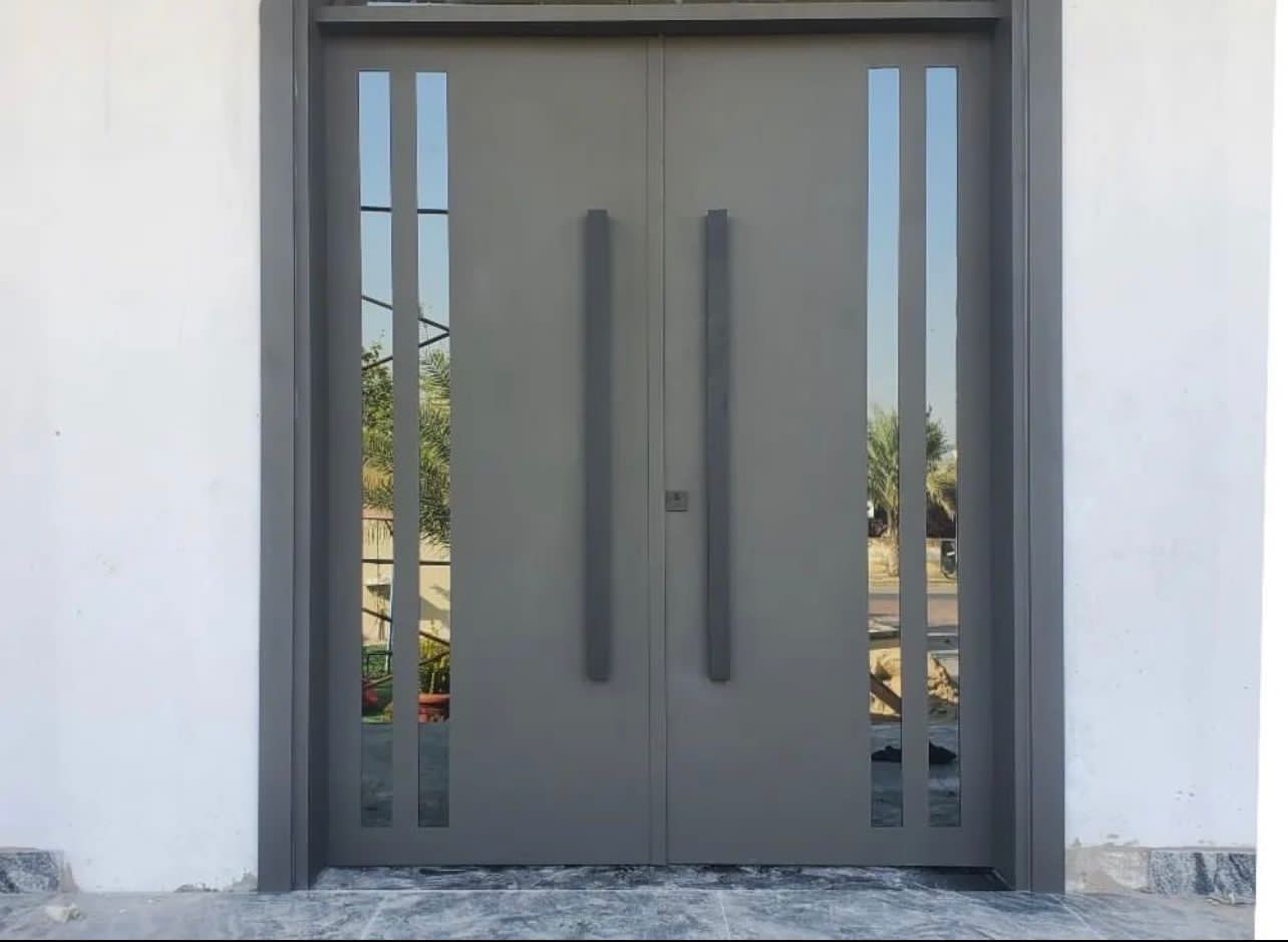 Modern pivot entrance door at a villa