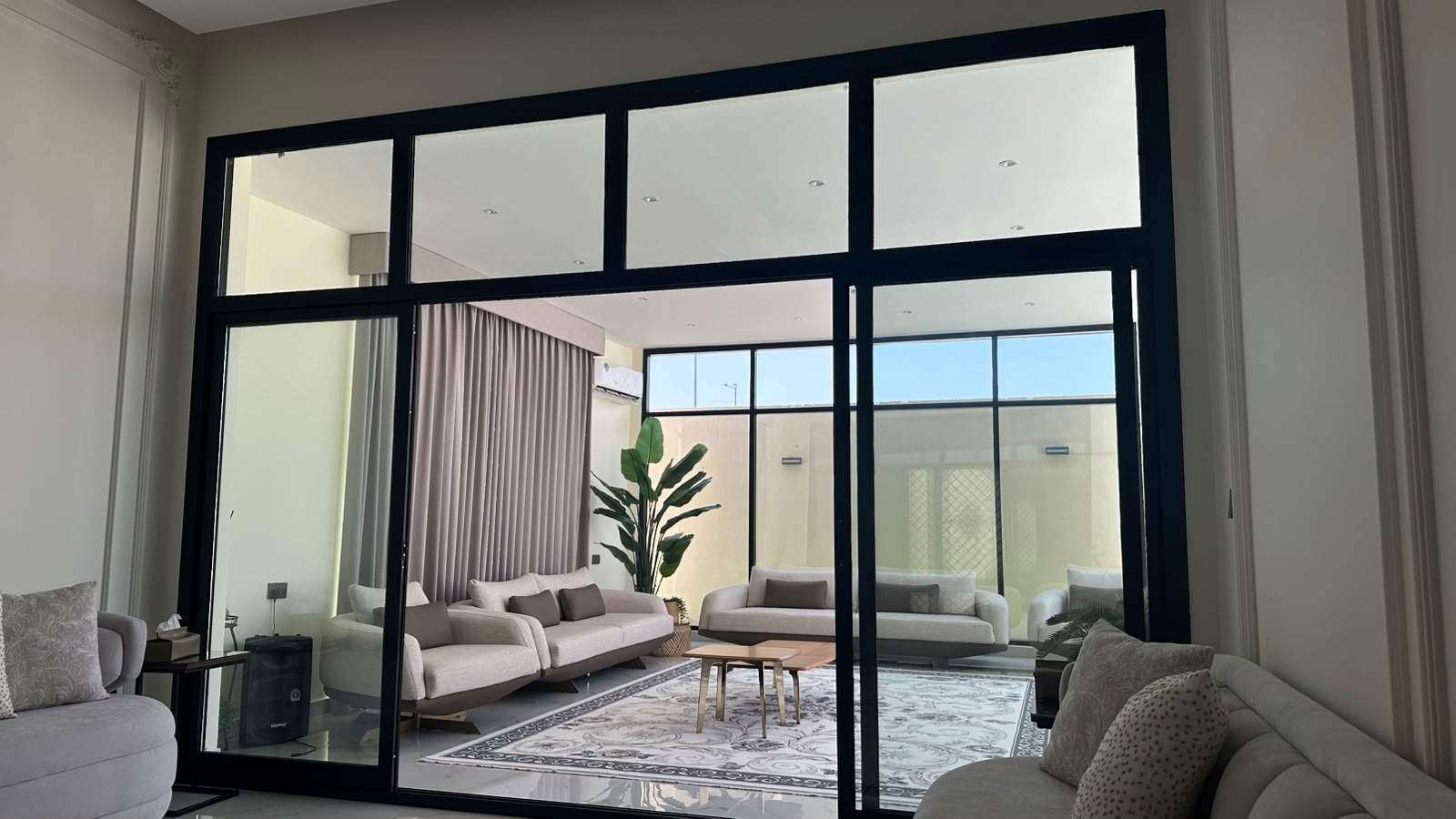 Furnished majlis with full-height glazing, Al Shamkha.